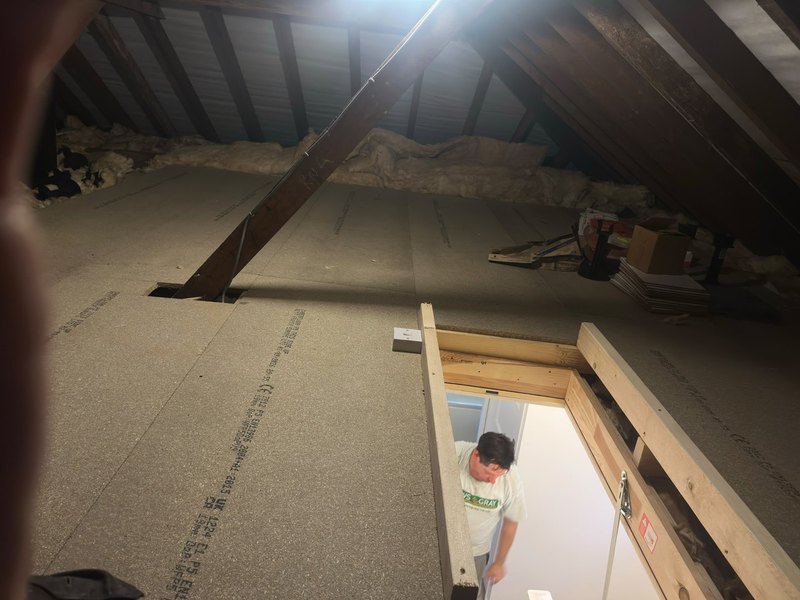 Completed loft boarding with timber access ladder and hatch opening at a Bristol property