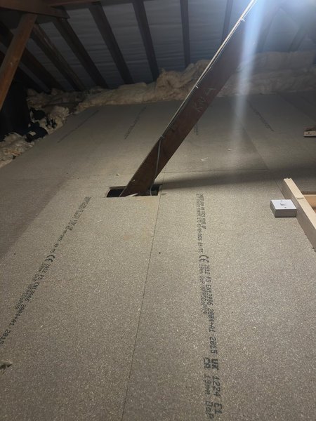 Loft floor boarding fitted around diagonal roof timbers on a Bristol project by Geoff Thomas