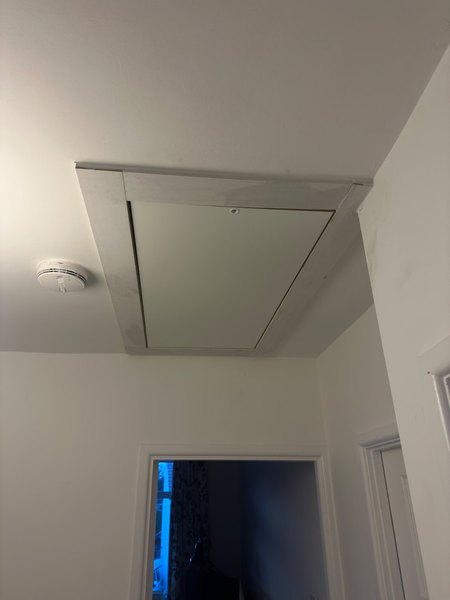 Closed loft hatch viewed from the landing below at the Bristol property